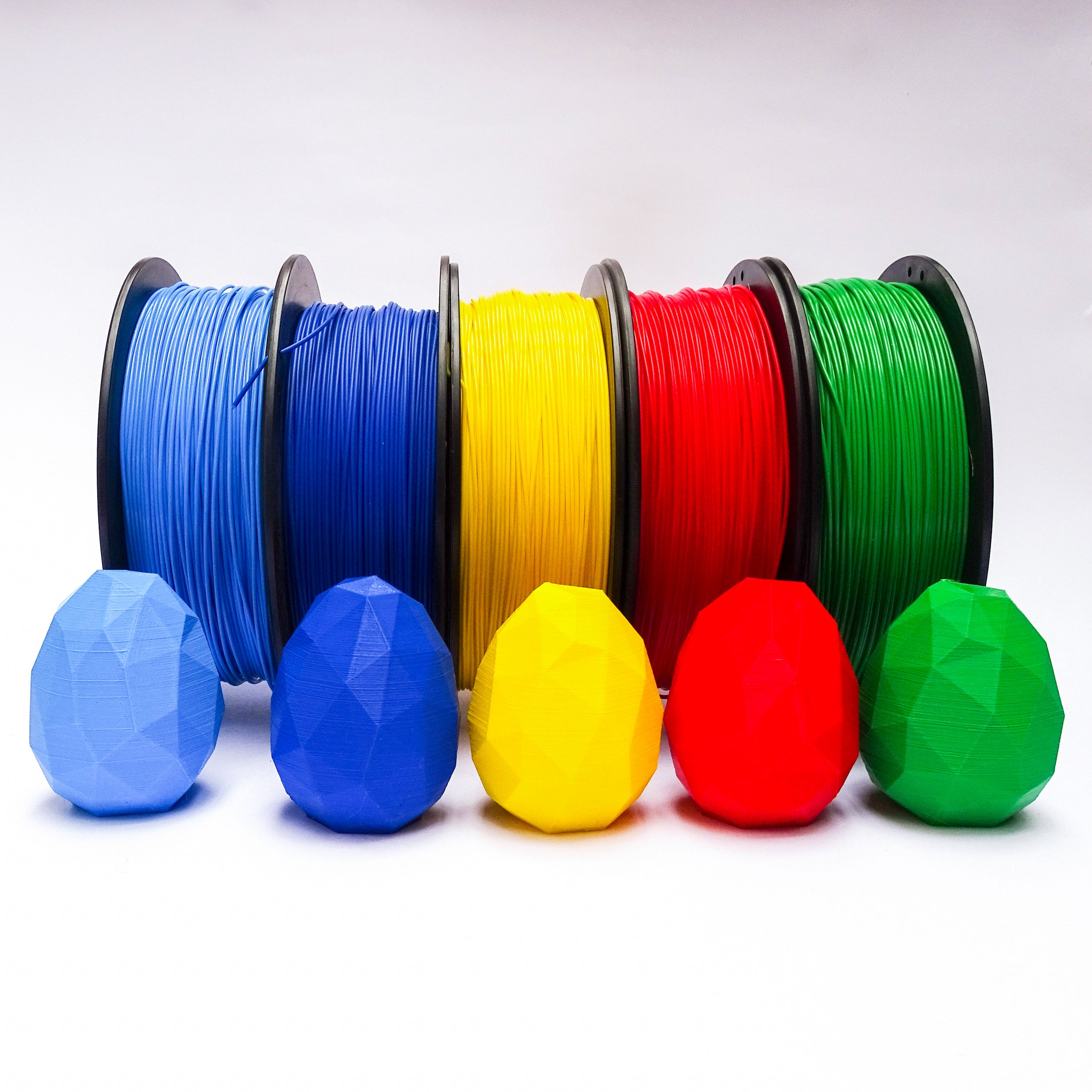 cinco filamentos pla Print3x Celeste, azul, amarillo, rojo y verde con impresiones 3d de huevos impresos printex printec print3c